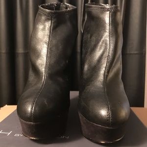 Black leather wedge heels.